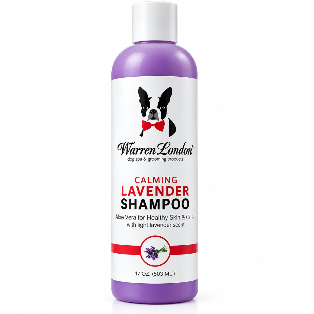 A bottle of Warren London Calming Lavender Shampoo stands next to a small light-colored dog on a plain white background. The bottle is lavender purple with a white cap and a white label featuring a black-and-white dog graphic and red text.