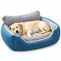 Dog resting on a blue and gray pet bed in a cozy room.