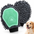 Pet grooming brush with green silicone pad and gray bristles, next to a dog.